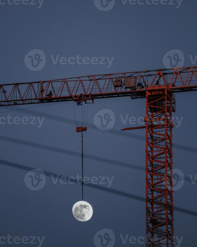 full moon and construction crane at night photo