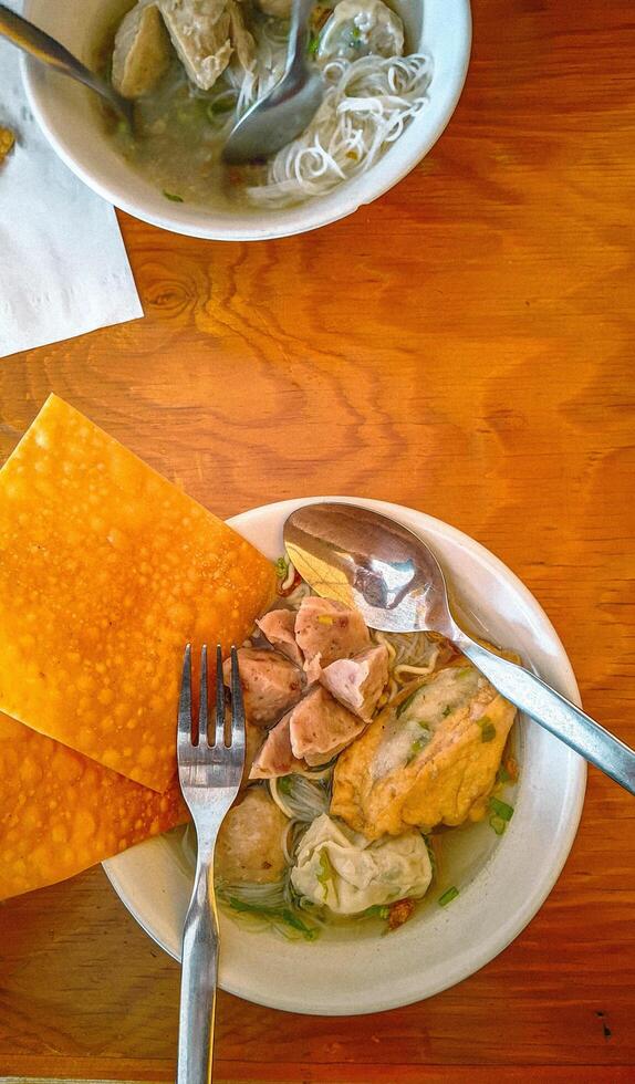 A table with a bowl of food and a plate of food photo