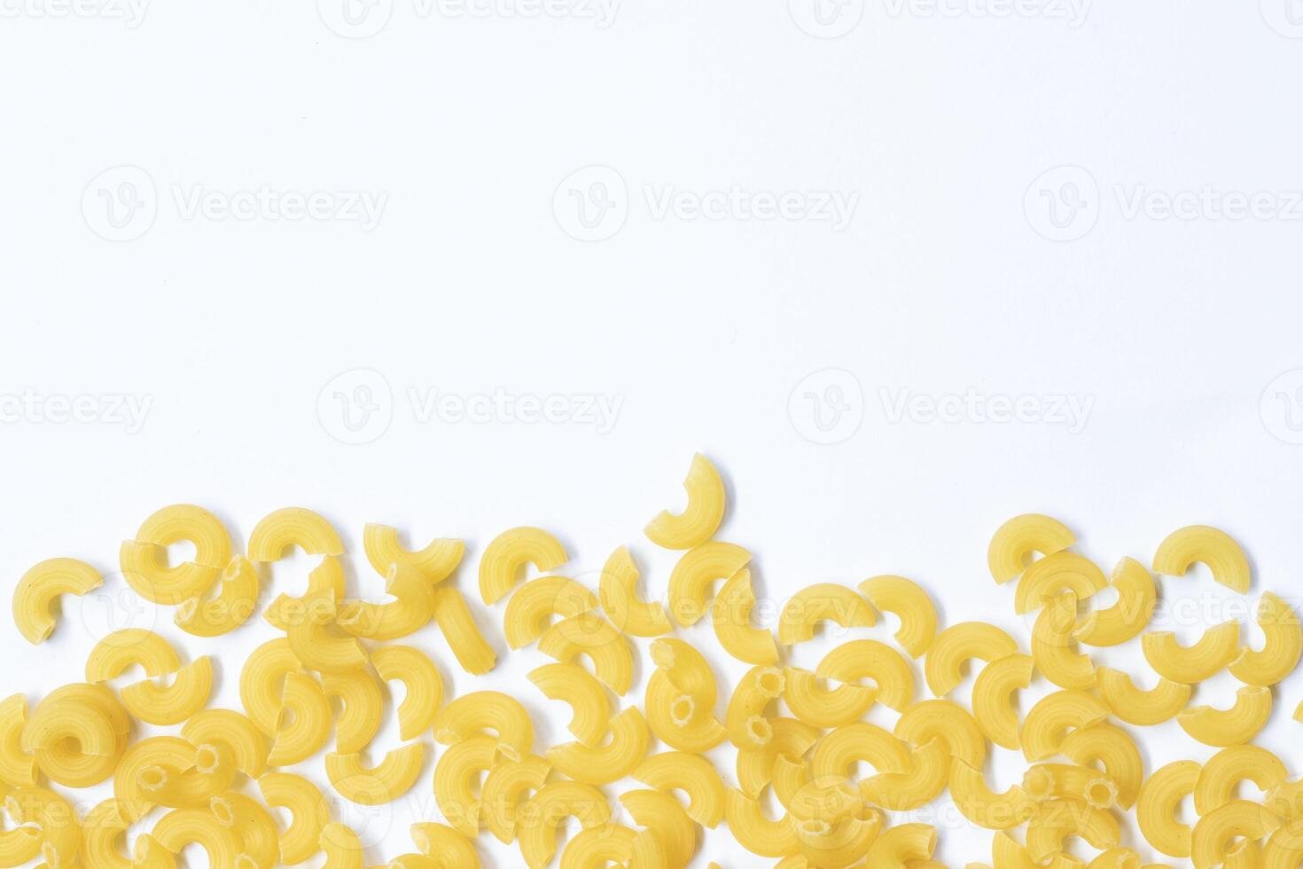 raw macaroni pasta isolated on white background with full depth of field. Top view. Lay flat photo