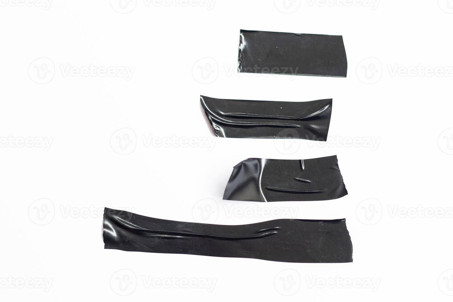 Collection of black ribbons on white background. Horizontal torn black adhesive tape and different sizes, adhesive pieces. photo