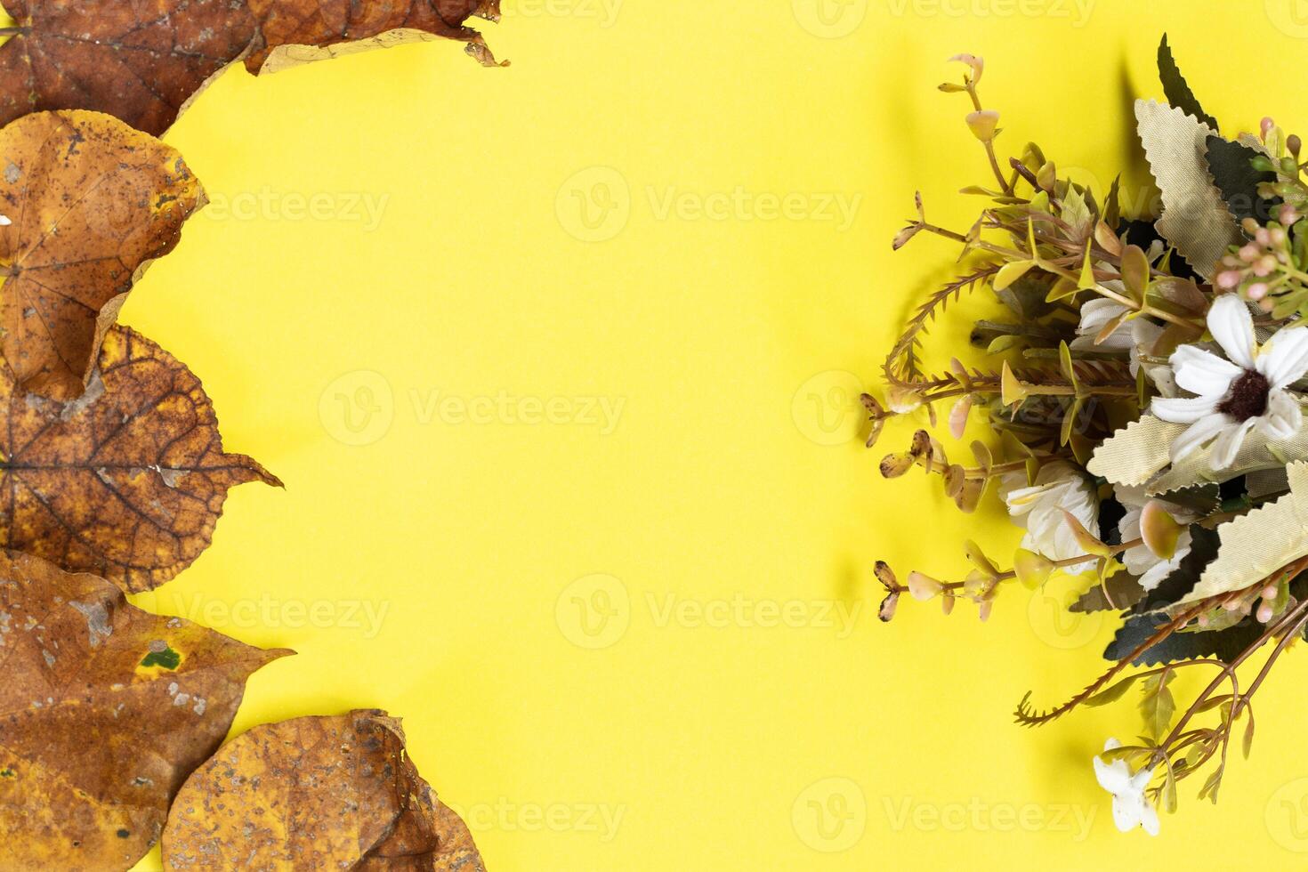 Mother's Day concept. Top view vertical photo of gold leaf on isolated yellow background with empty space