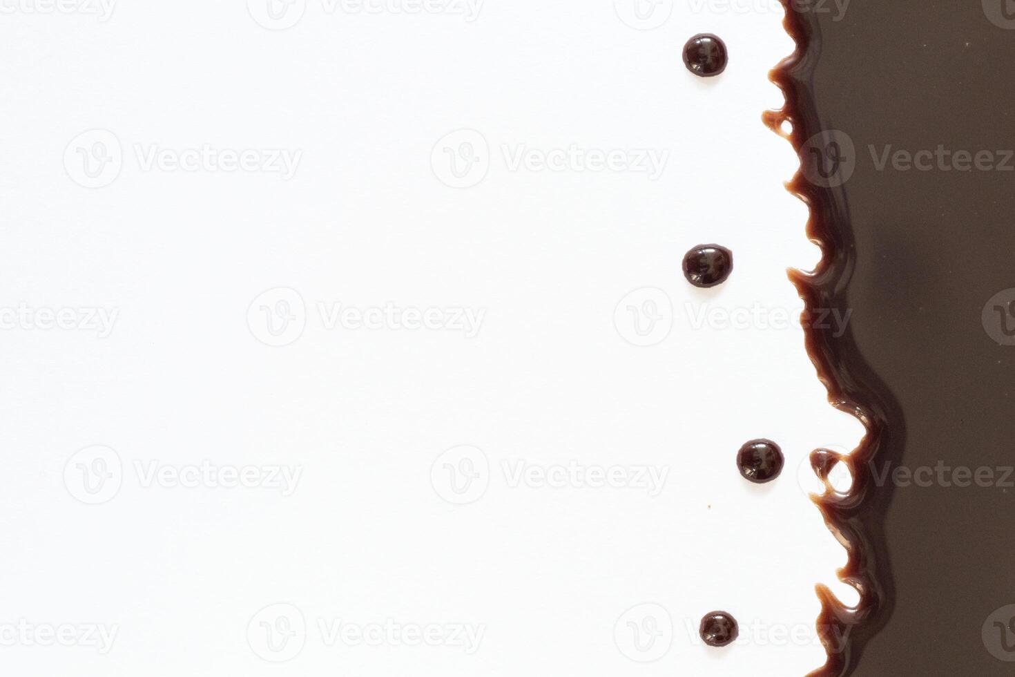 Melted dark or milk chocolate over cake isolated on white photo