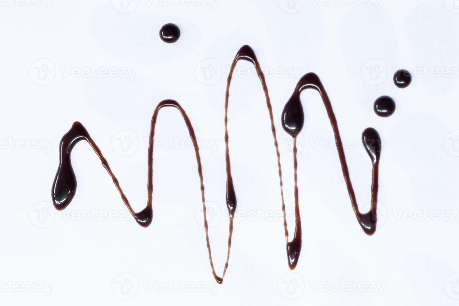 Chocolate syrup drizzle isolated on white background. A splash of sweet chocolate sauce. photo