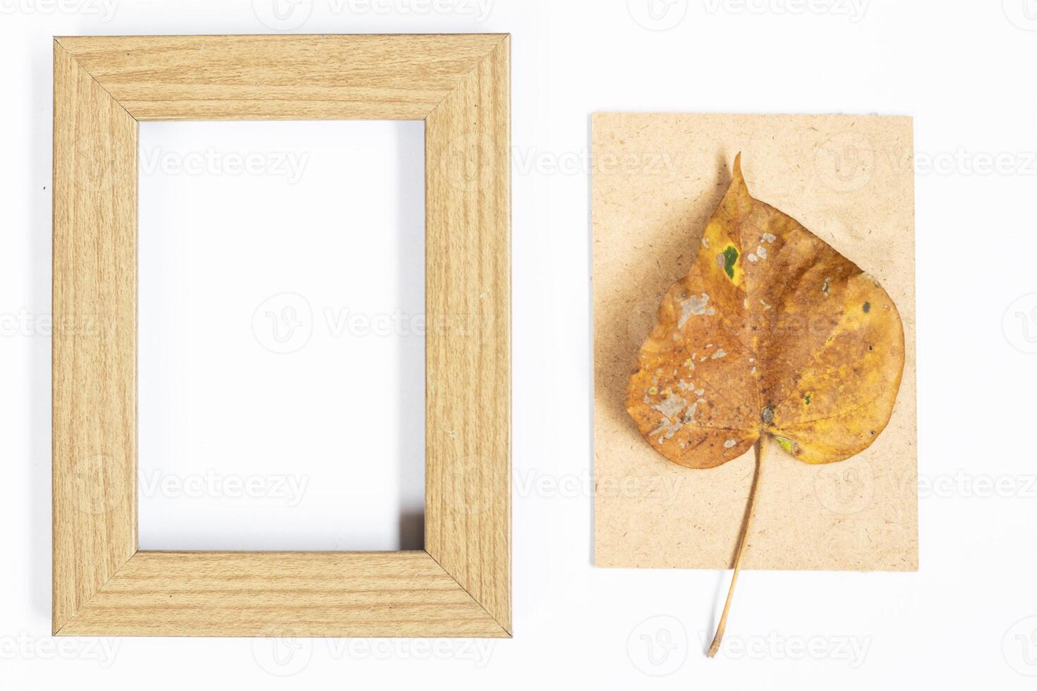 Autumn composition. Photo frame, maple leaves, on white background. Flat lay, top view, copy space.