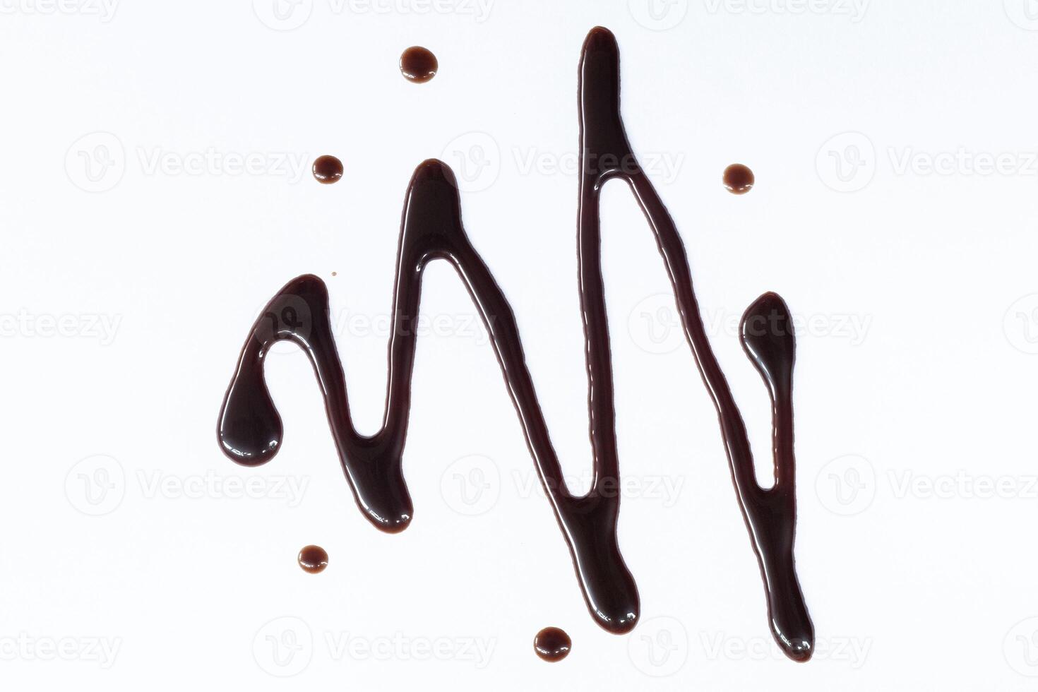 Chocolate syrup drizzle isolated on white background. A splash of sweet chocolate sauce. Top view. photo