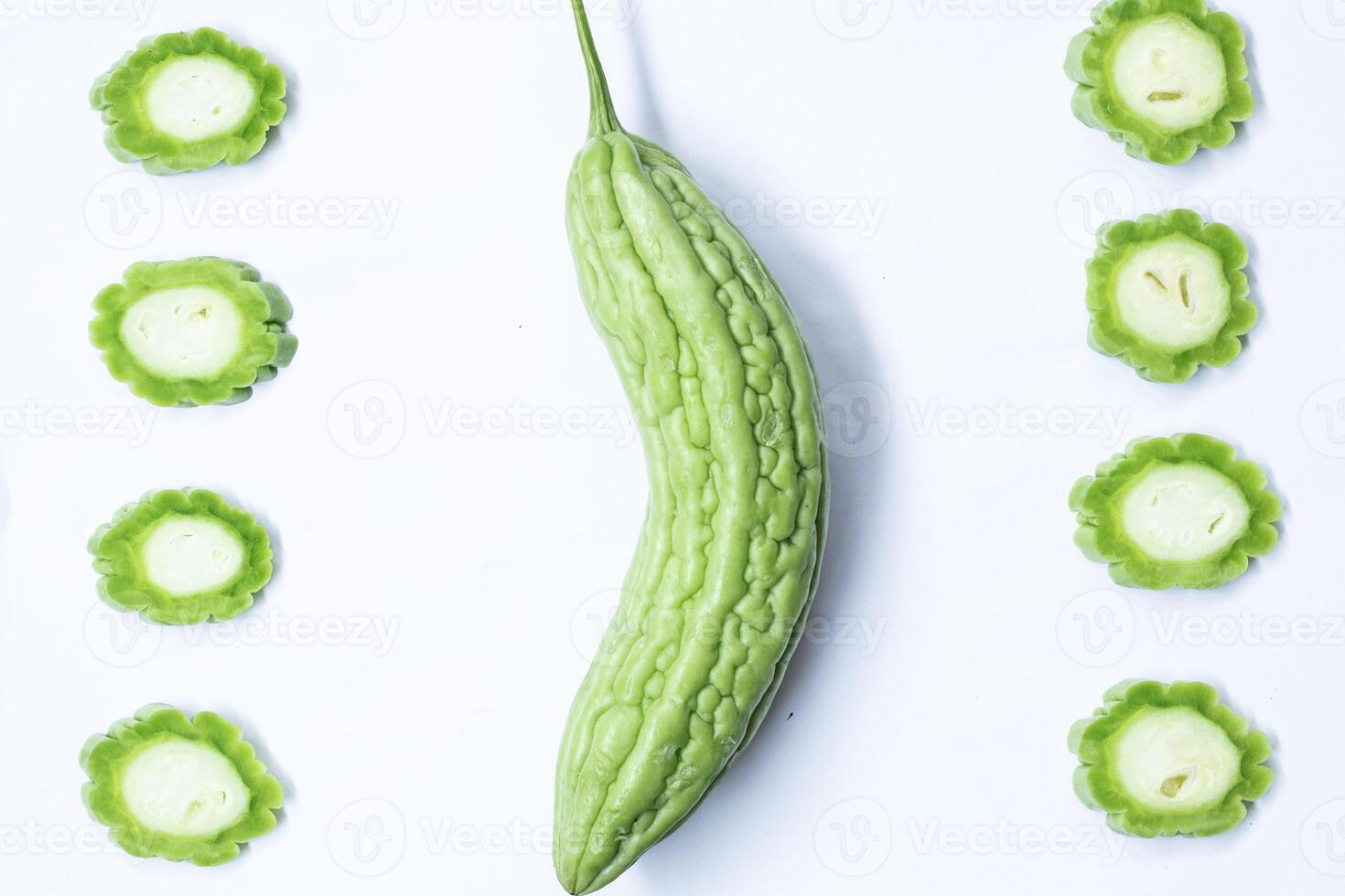 Beautiful arrangement of Chinese Bitter gourd or Bitter melon on a white background with soft shadows, small pieces and large pieces put together. photo