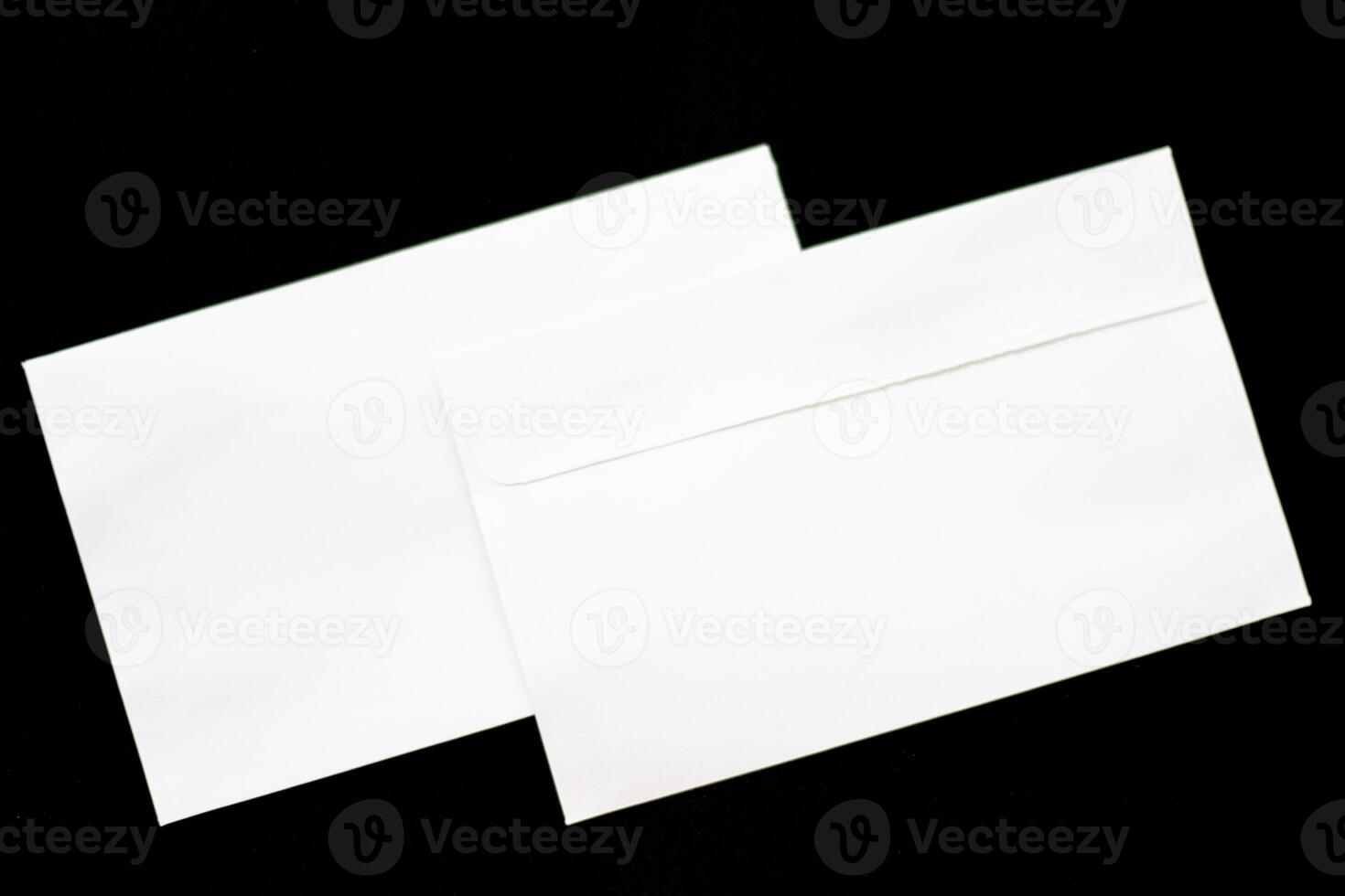 Set of white envelopes isolated on a black background photo