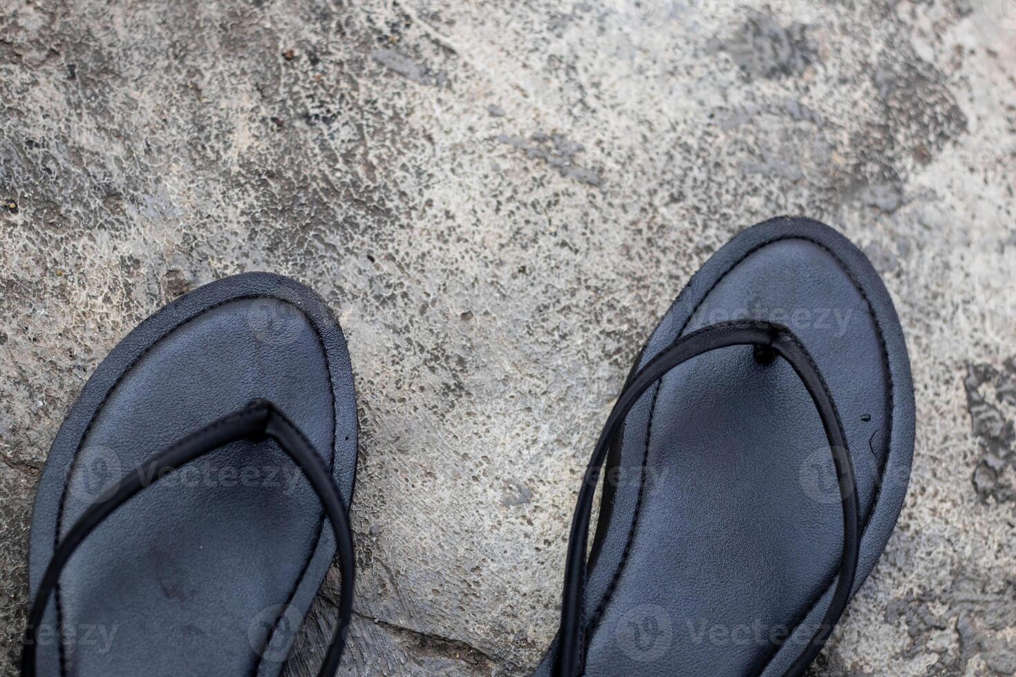 pair of black flip flops top view photo