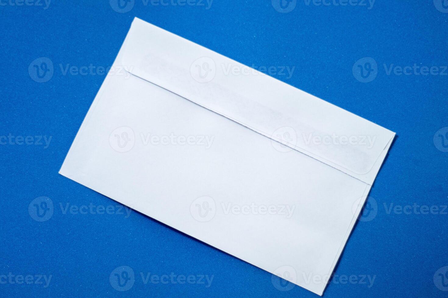 Set of white envelopes sealed, empty and with blank paper inside, isolated on a blue background photo