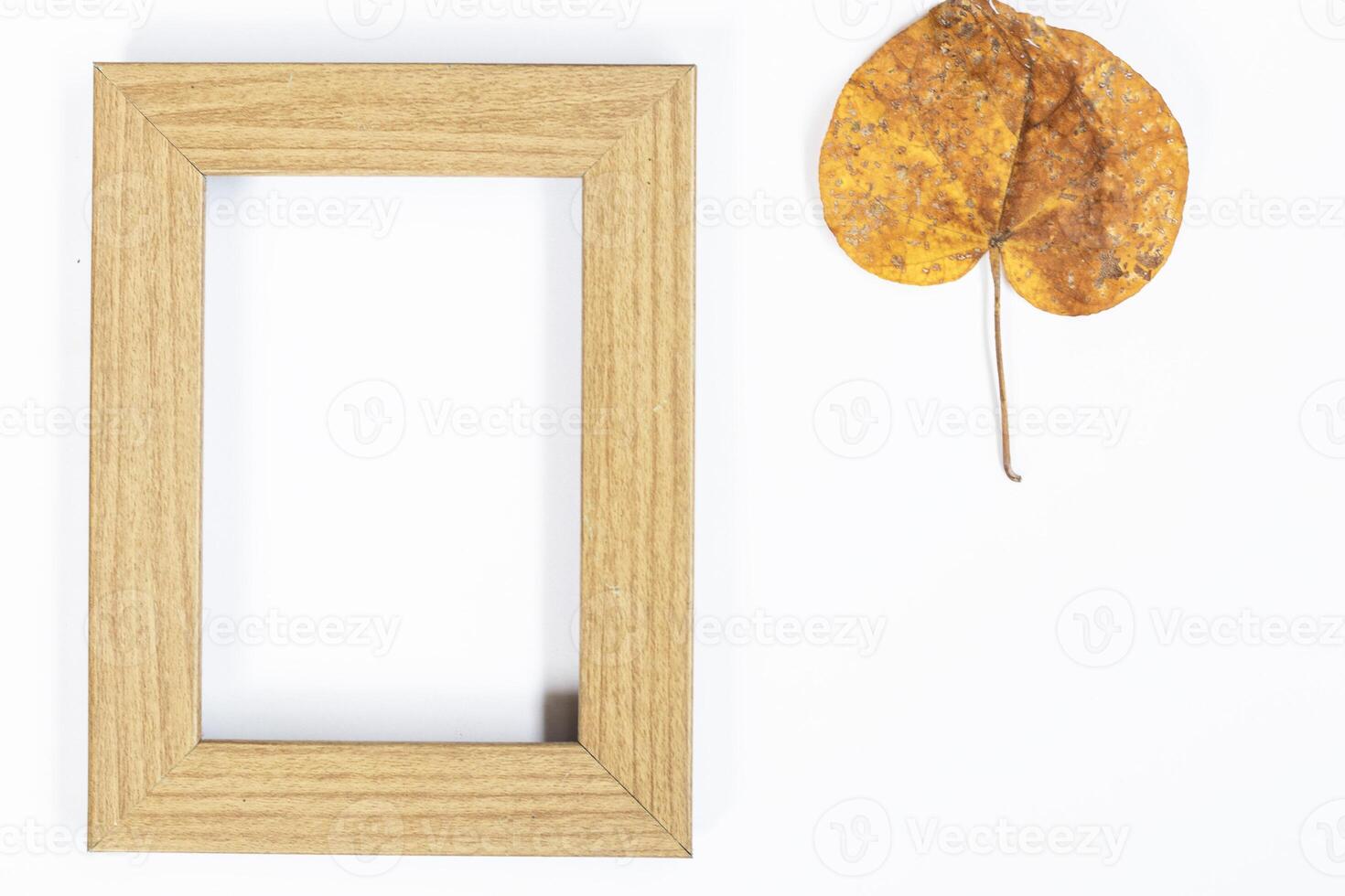 Autumn composition. Gold leaf, photo frame on white background. Autumn, autumn concept. Flat lay, top view, copy space