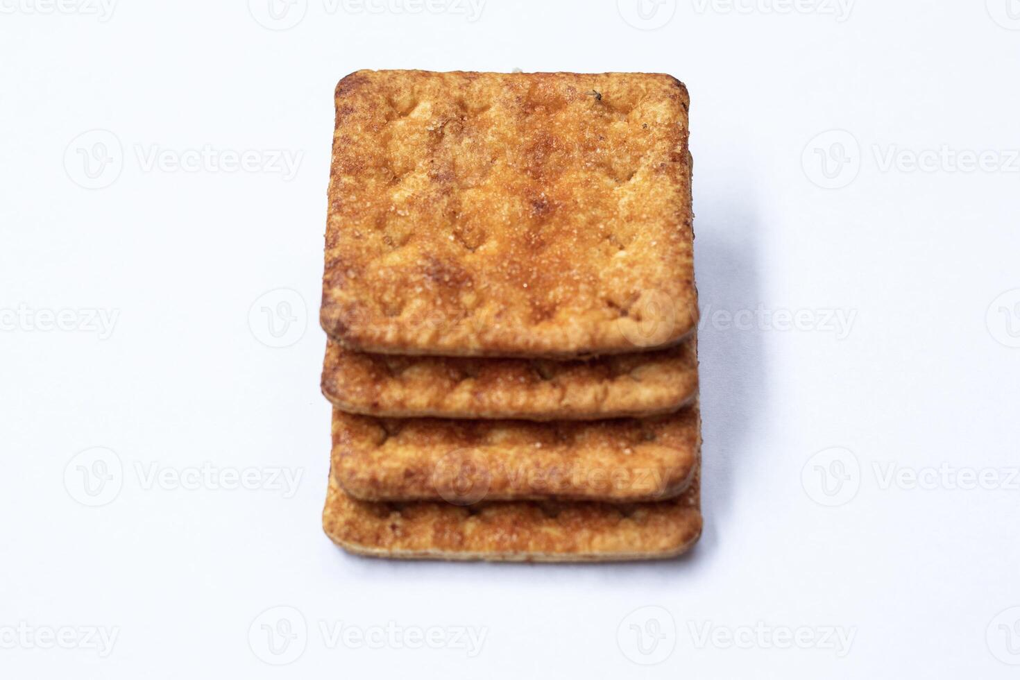 Stack of four rectangular butter biscuits isolated on white. photo