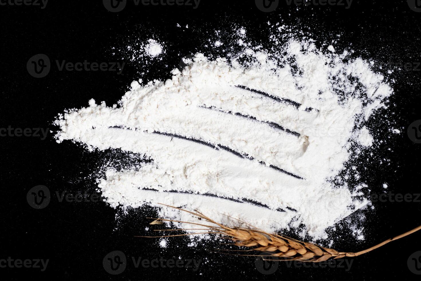 Wheat ears and flour in the background photo