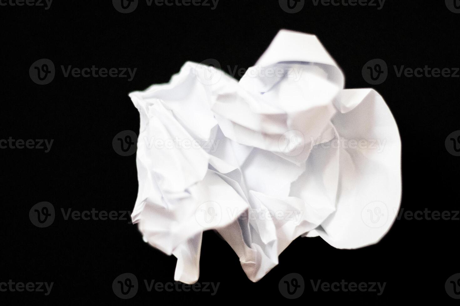 crumpled paper for the texture on black background photo
