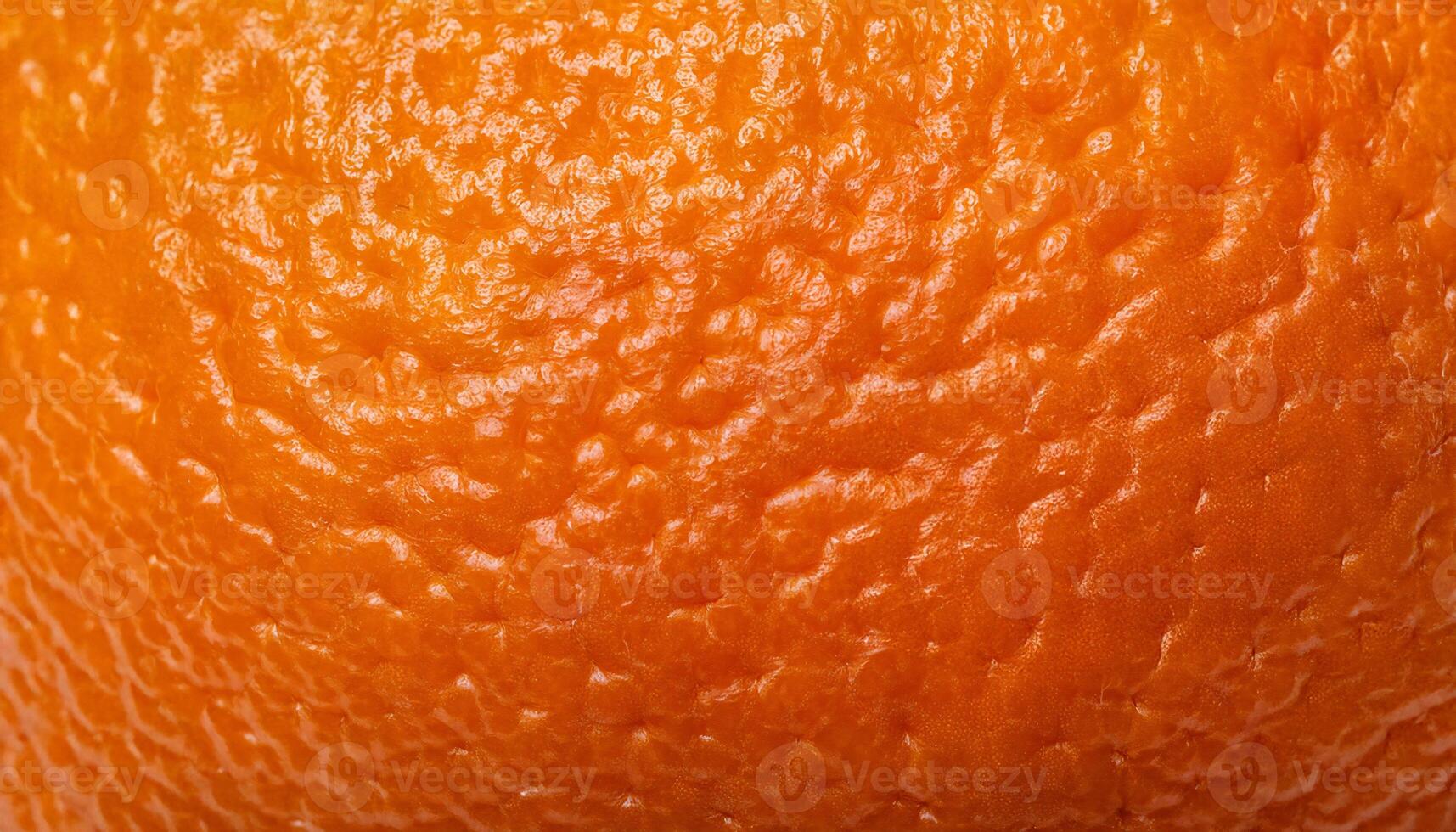 macro close-up of tangerine peel showcasing its vibrant orange color and detailed bumpy texture photo