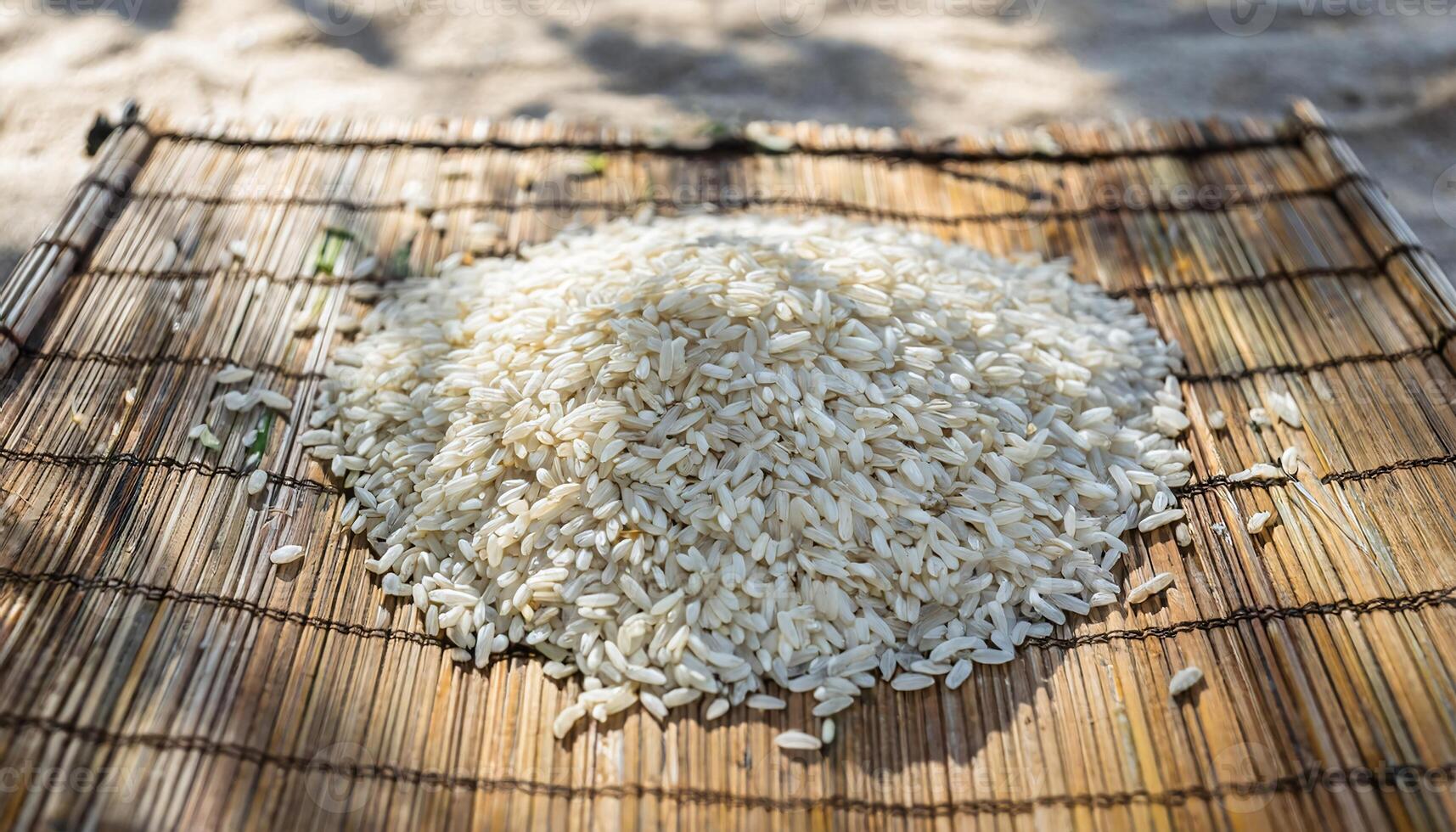 close-up of rice grains drying in the sun on a bamboo mat showcasing traditional food preparation in rural settings photo