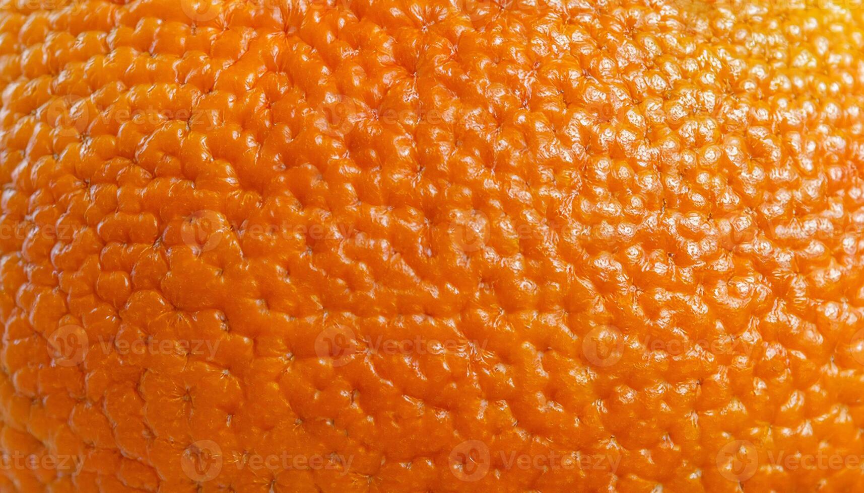 close-up of mandarin orange peel showcasing its vibrant color and bumpy textured surface photo