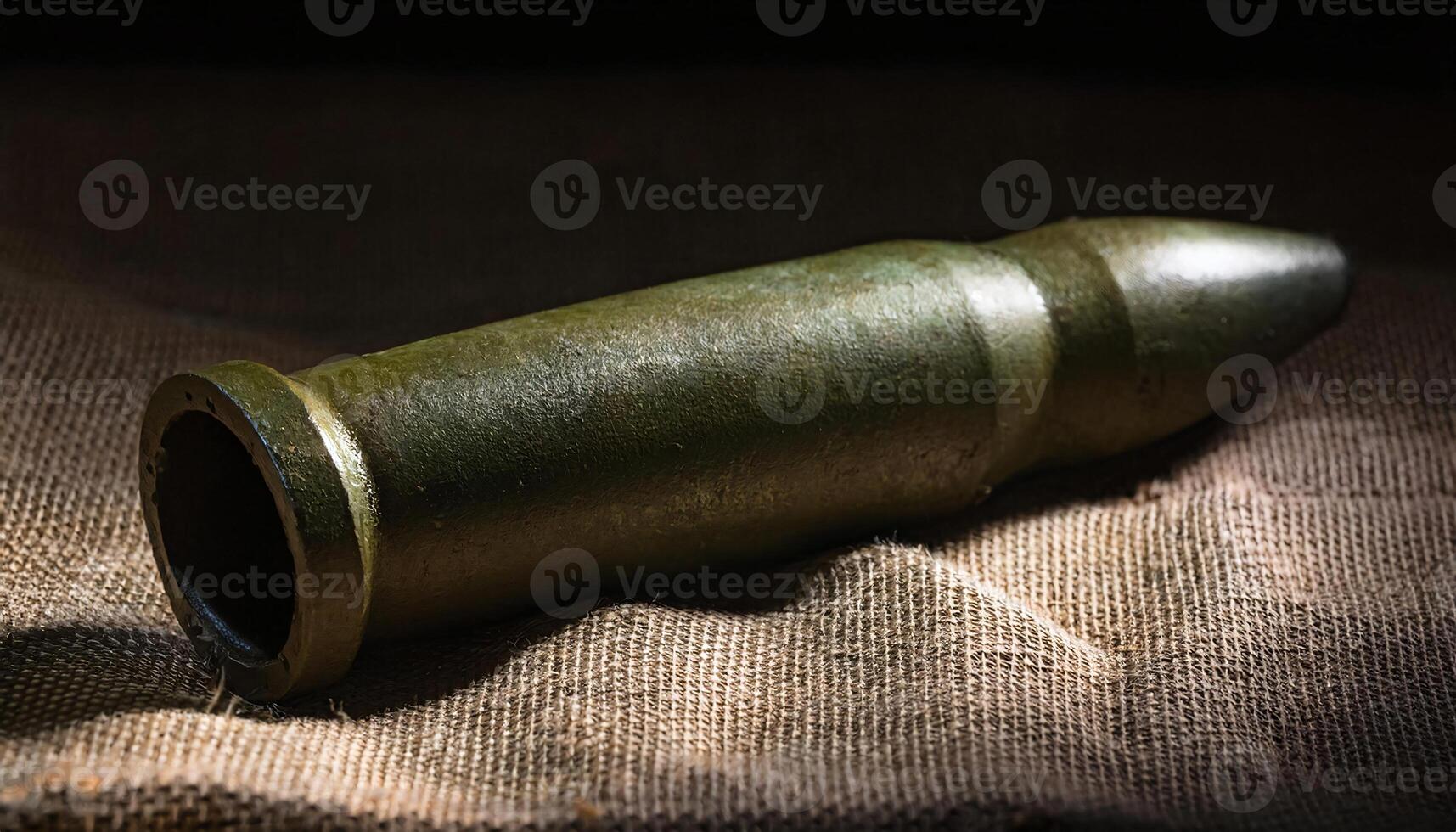 detailed close-up of a vintage mortar shell resting on burlap fabric with visible textures and shadows photo
