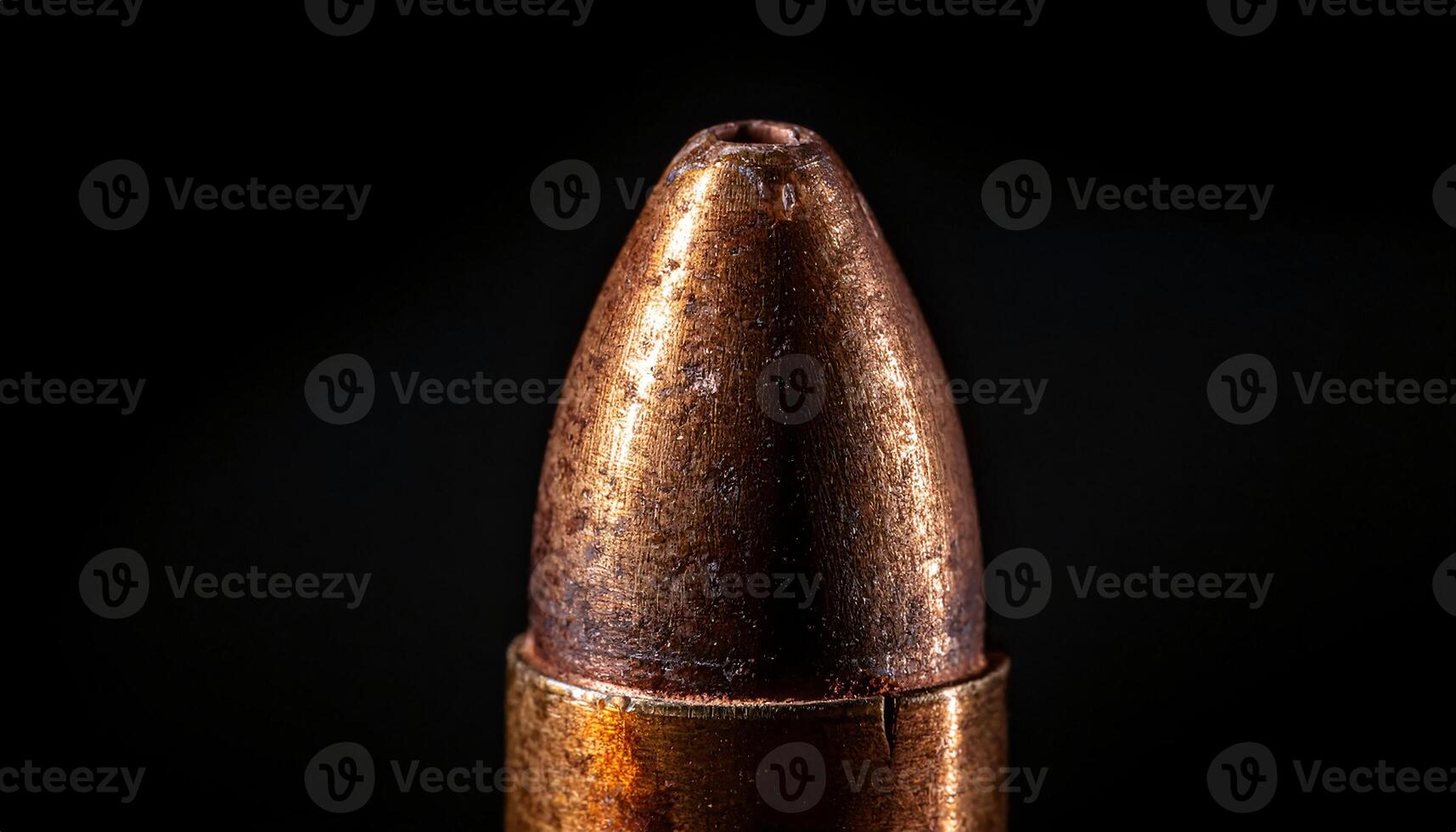 macro view of aged bullet with engraved markings and textured metallic surface against dark background photo