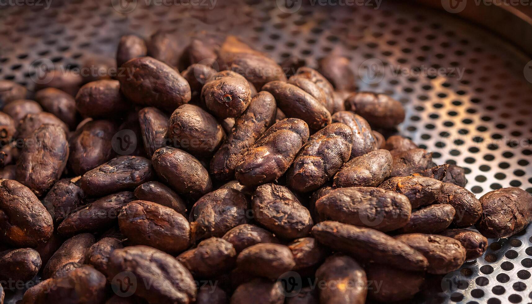 close-up of freshly roasted cacao beans on a perforated metal tray, showcasing rich texture and earthy tones photo