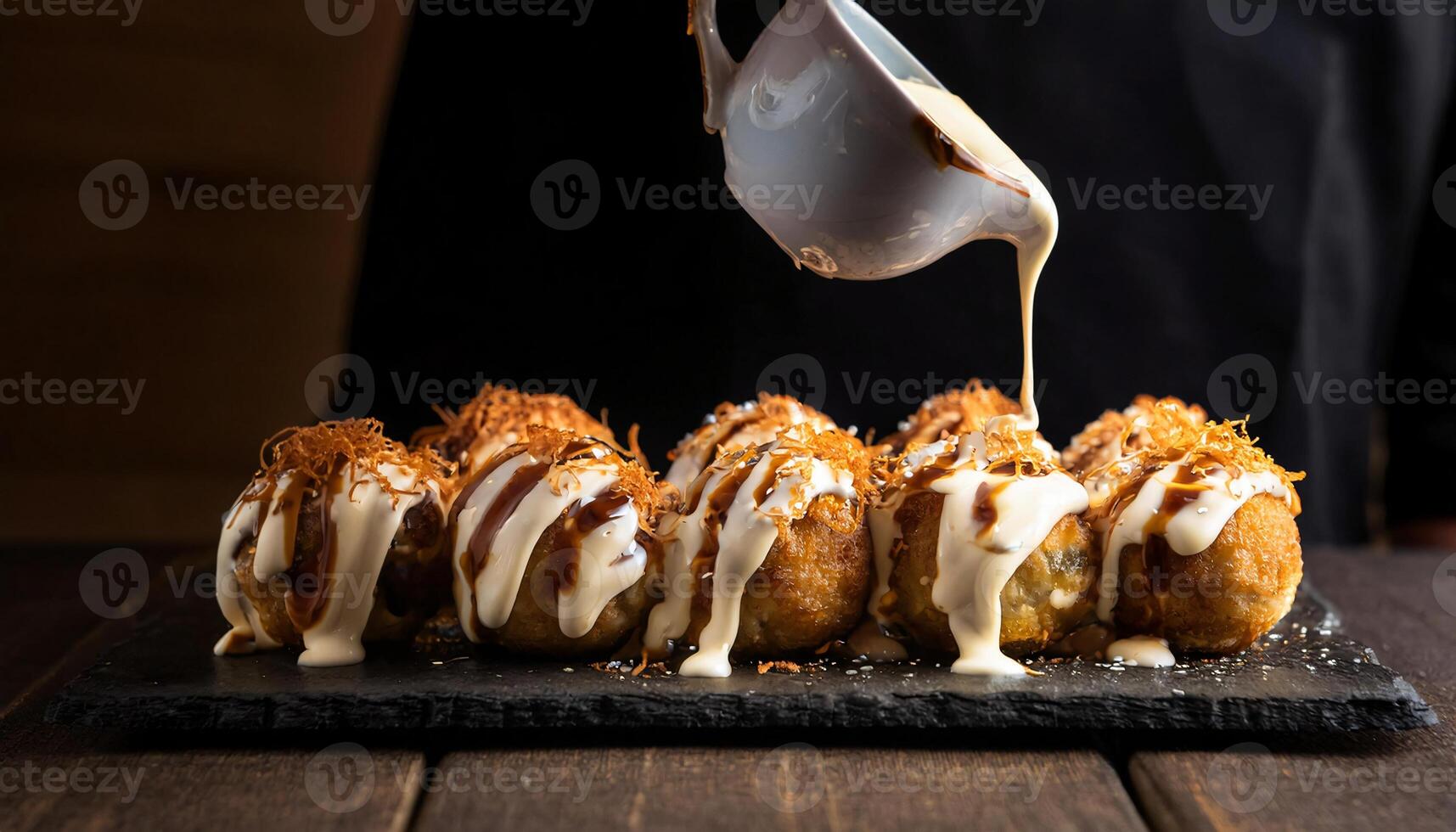 close-up of japanese takoyaki drizzled with mayonnaise and sprinkled with bonito flakes photo