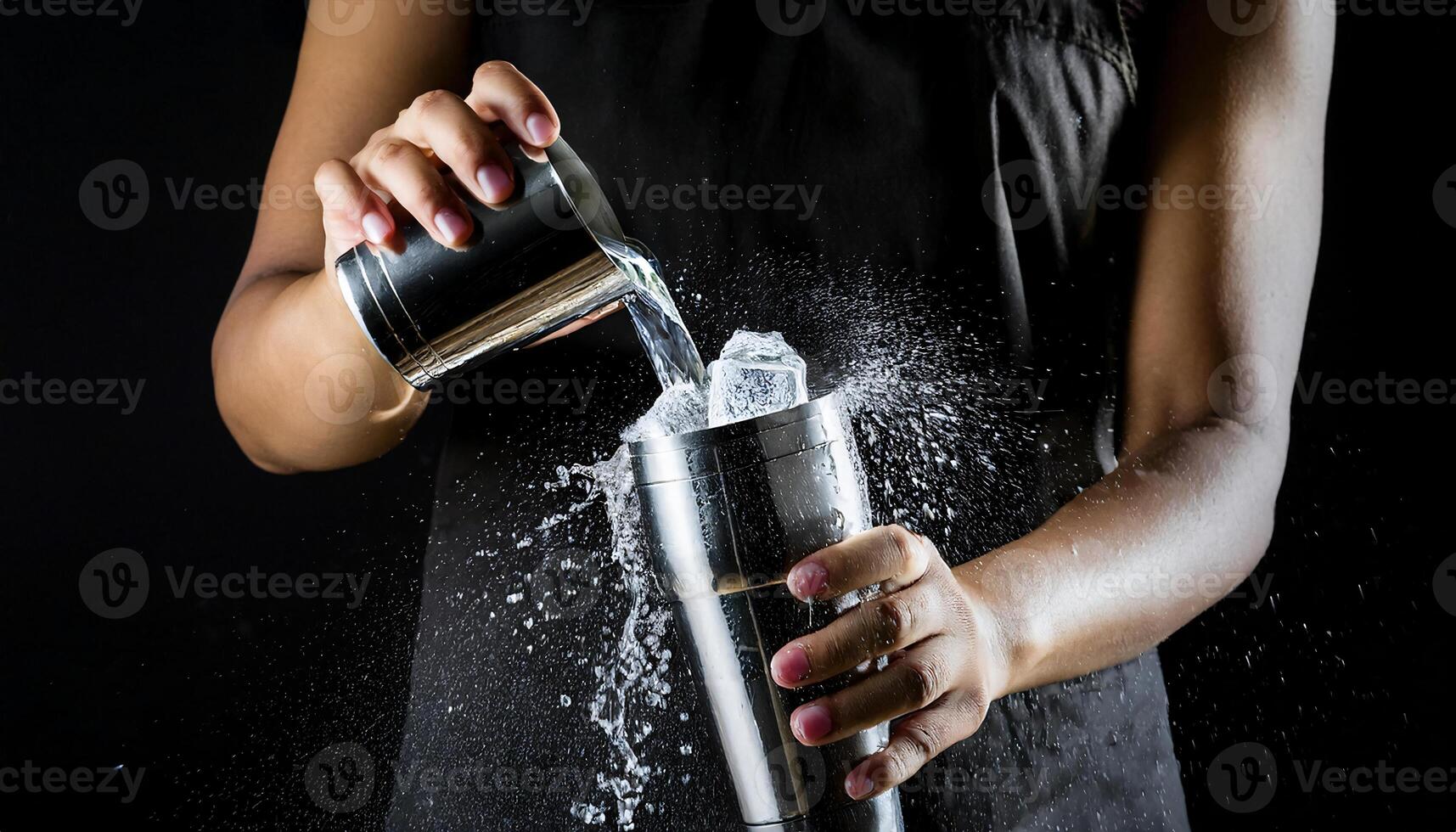 close-up of a bartender hands pouring liquid into a cocktail shaker with splashing water and visible ice cubes in a dynamic motion photo