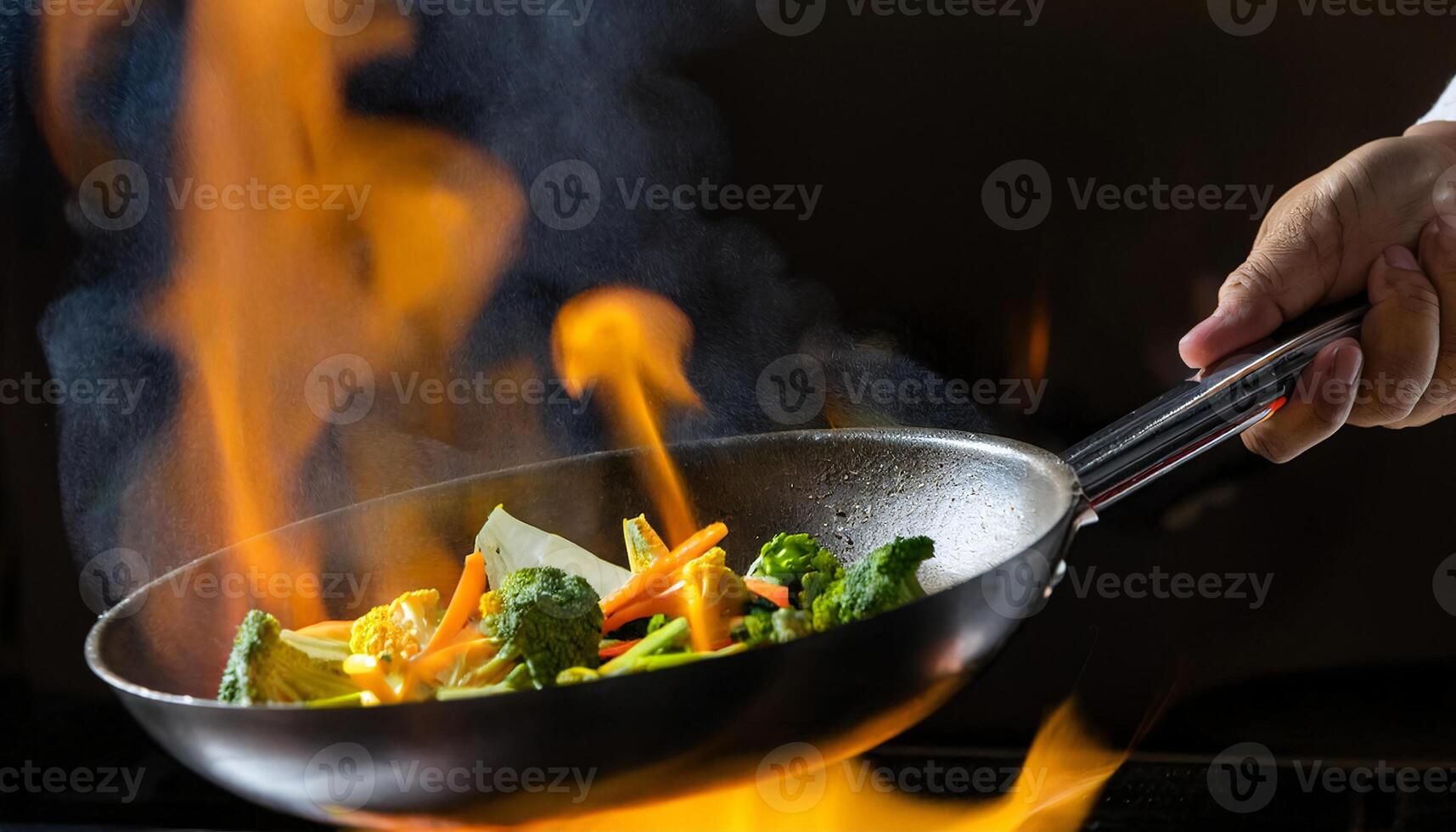 close-up of chef flipping a sizzling pan of fresh vegetables over vibrant flames in a professional kitchen photo