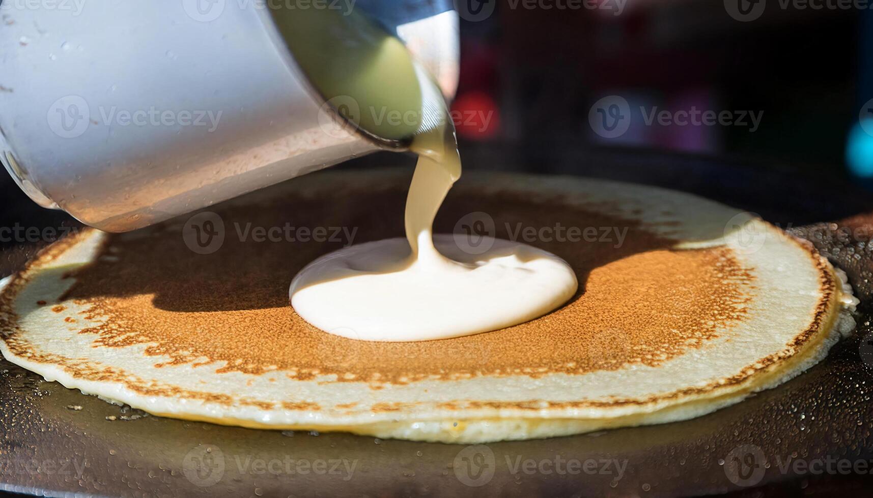 pouring pancake batter onto a sizzling griddle for golden, fluffy pancakes photo