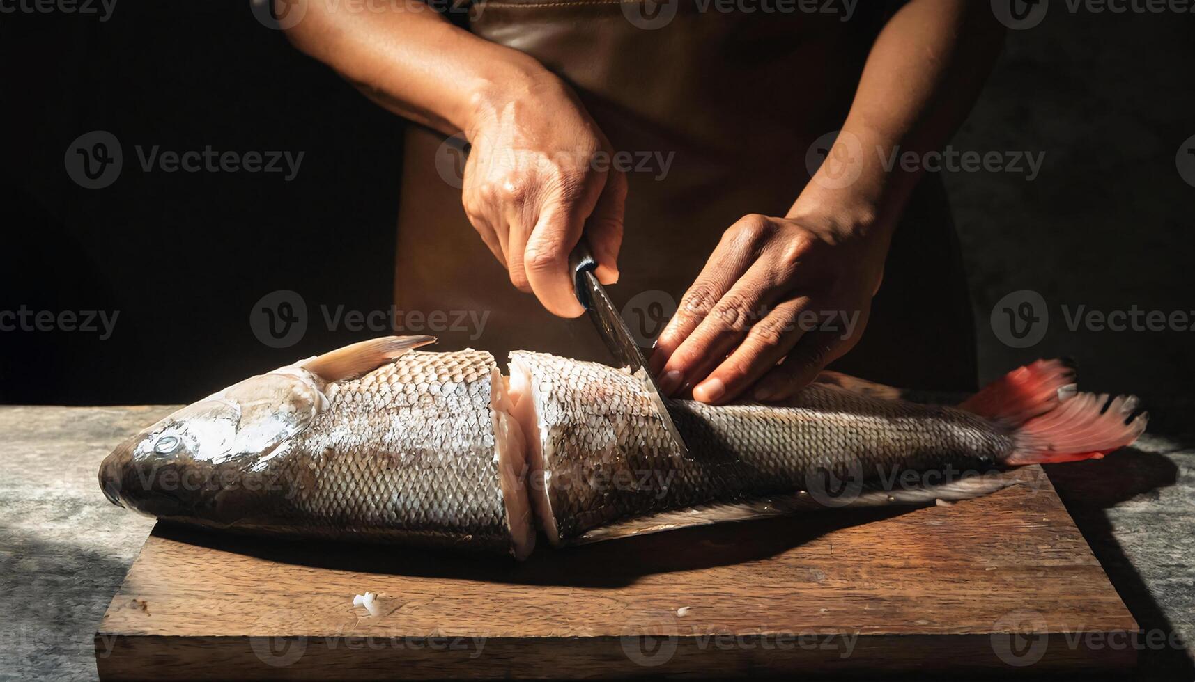 close-up of a chef hands filleting a whole fish with precise cuts on a wooden cutting board, showcasing clean flesh and professional preparation photo