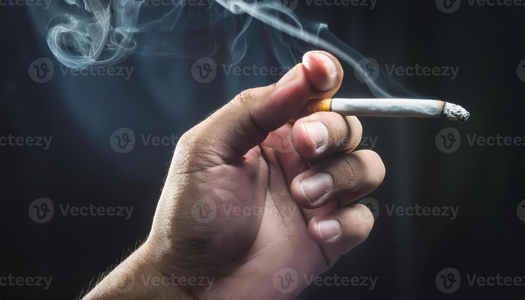 close-up of hand holding a burning cigarette with smoke rising gently against a dark background, symbolizing smoking habits and health risks photo