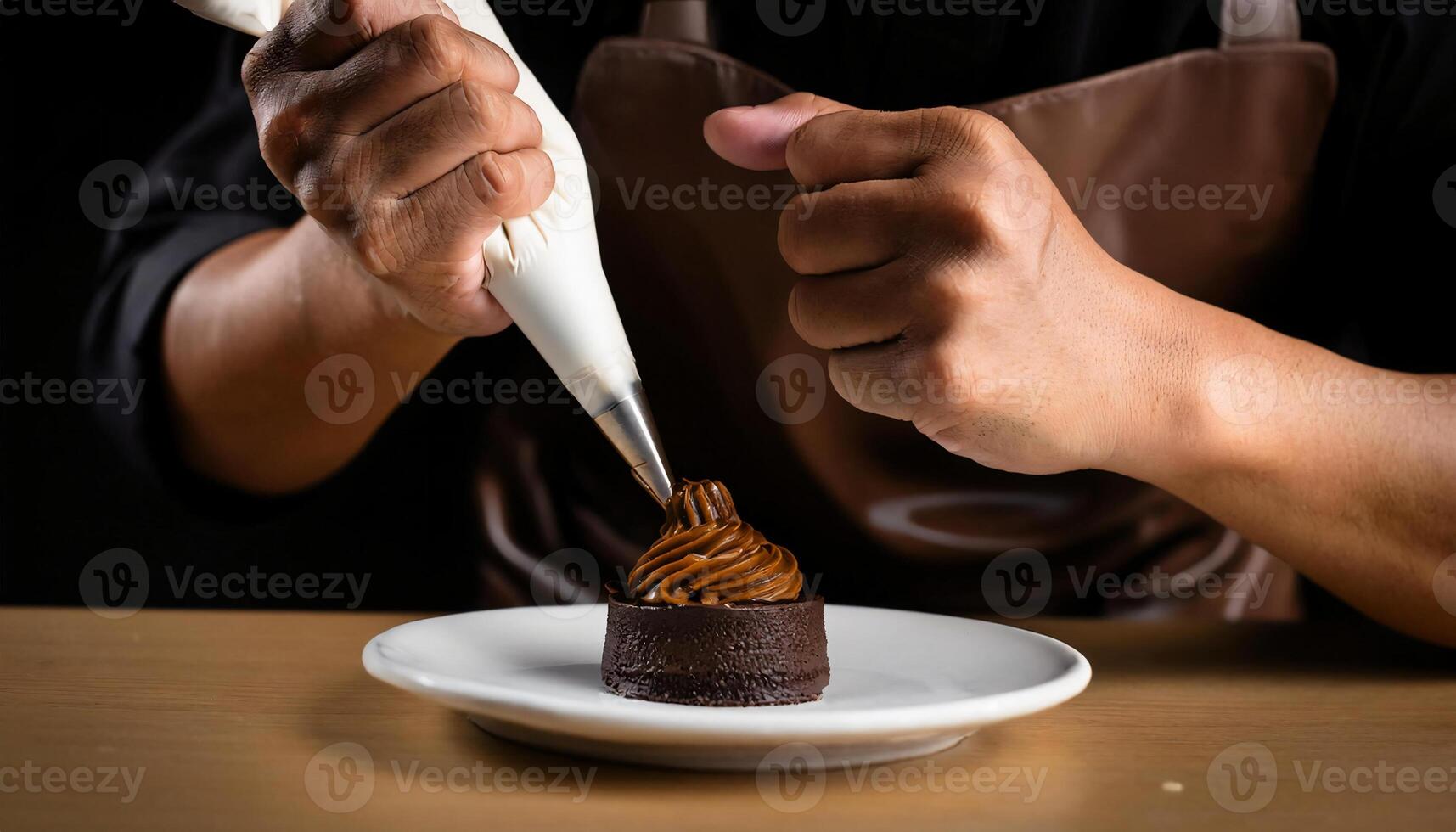 close-up of a pastry chef decorating a chocolate dessert with a piping bag, showcasing detailed chocolate swirl frosting on a rich chocolate cake photo