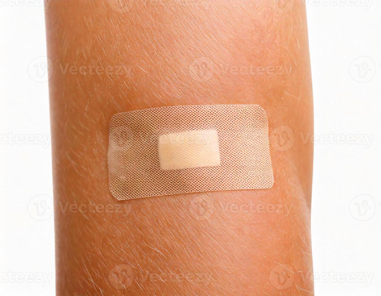 close-up of a healing wound with adhesive bandage applied on skin isolated on white background photo