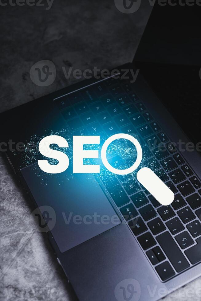 Search Engine Optimization concept. Laptop with SEO lettering. Use technology for search information. Marketing ranking traffic website. photo