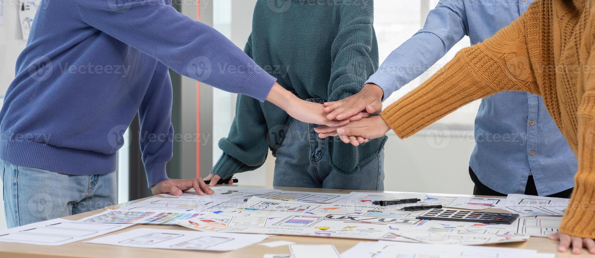 Application development team Stack of hands Working together to show unity in working on ux ui smartphone applications. photo