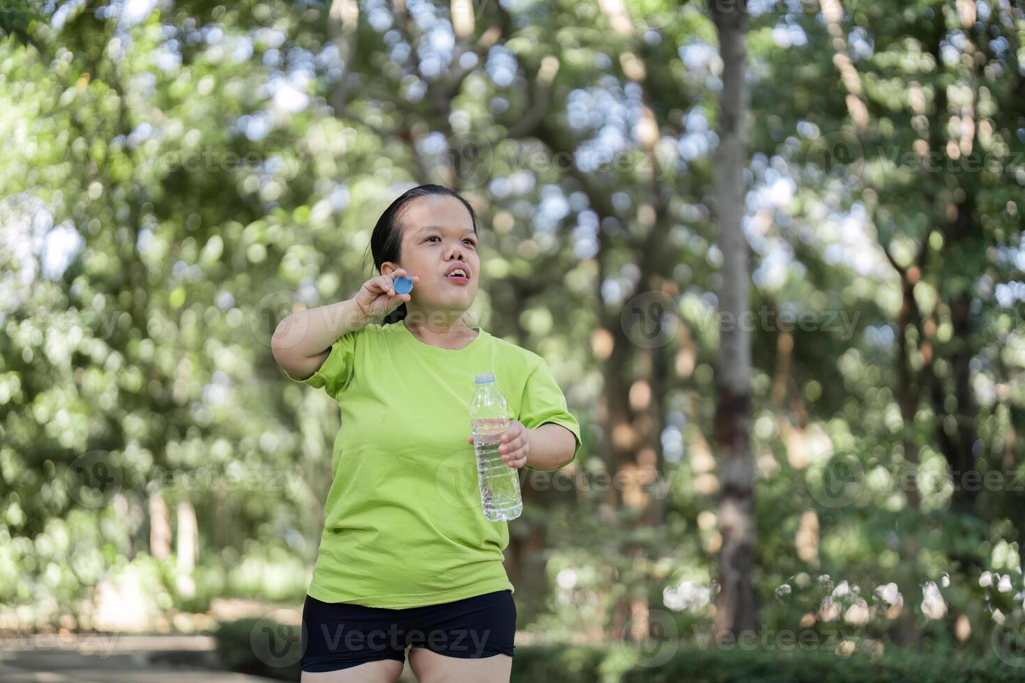 Woman Jogging in a Lush Garden Setting, Embracing Fitness and Nature in a Serene Outdoor Environment photo