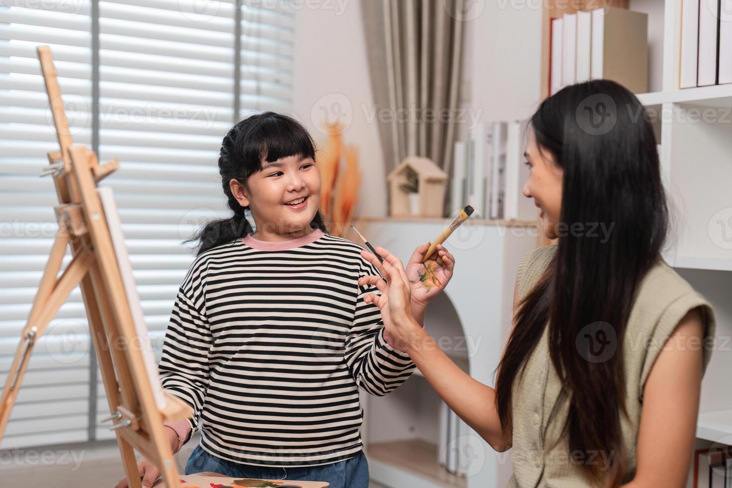 Mother and Daughter Enjoy Quality Time Together Creating Art and Drawing Pictures at Home photo