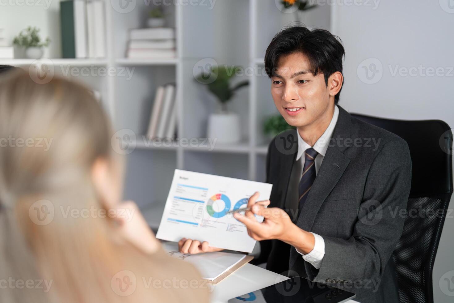 Professional Business Team Collaborating on Project Strategy and Analyzing Work Plans in Modern Office Setting photo