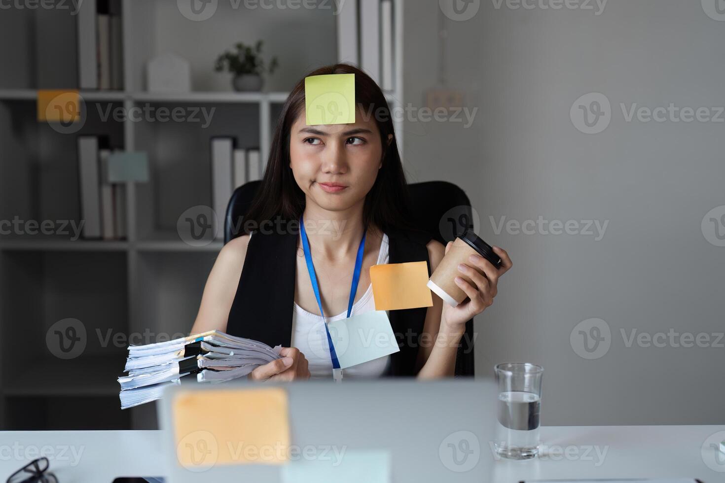 Busy Office Worker Managing Documents and Tasks in a Modern Workplace Setting photo