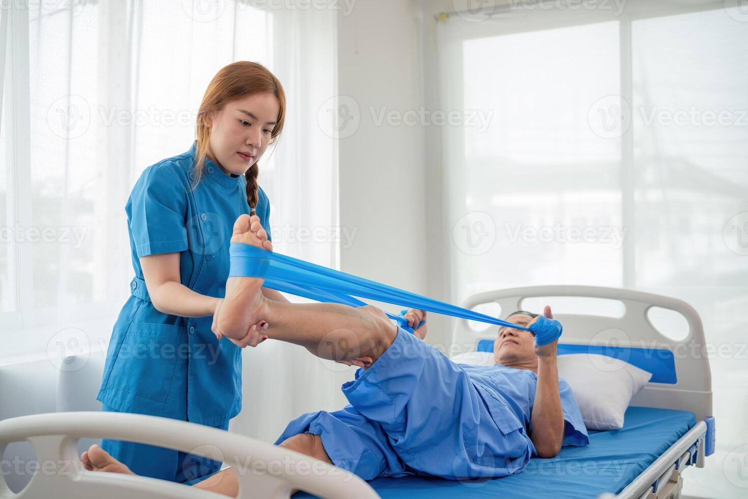Young Caregiver Assisting Elderly Patient with Physical Therapy in a Bright Modern Hospital Room photo