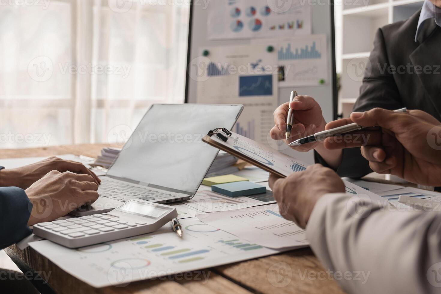Business Team Collaborating on Financial Reports and Strategies in a Modern Office Setting photo