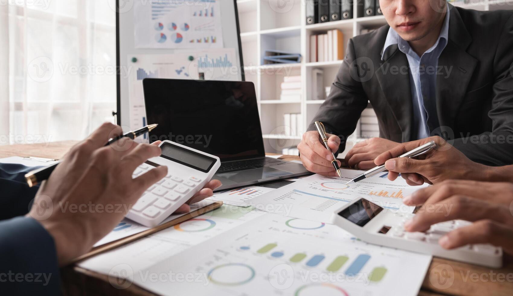 Business Team Collaborating on Financial Reports and Data Analysis in a Modern Office Environment photo