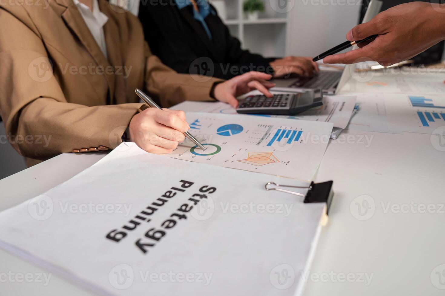 Business Team Collaborating on Strategic Planning and Analyzing Work Plans in a Modern Office Environment photo