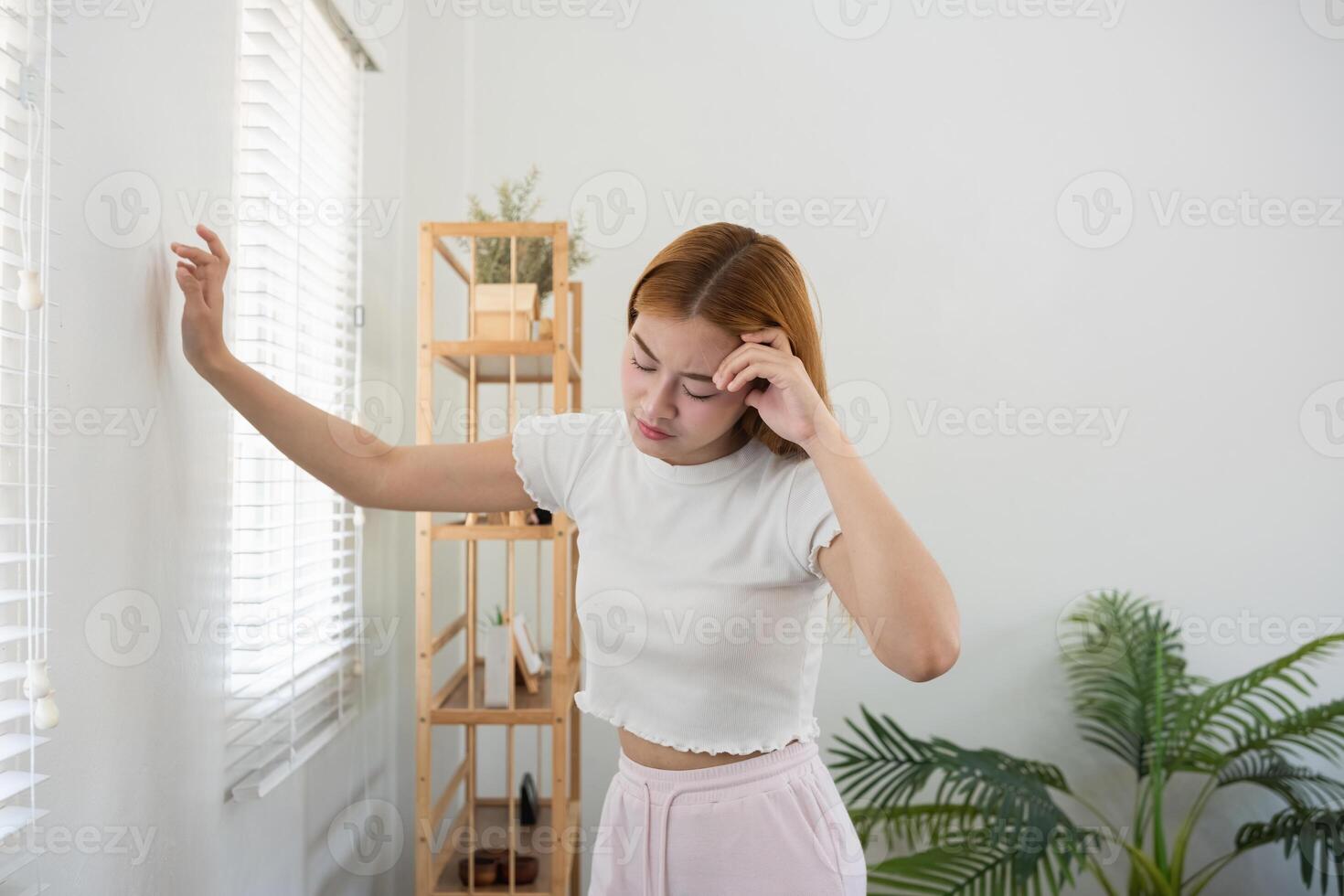 Asian woman feeling headache and stress at home. Concept of mental health, stress, and anxiety photo