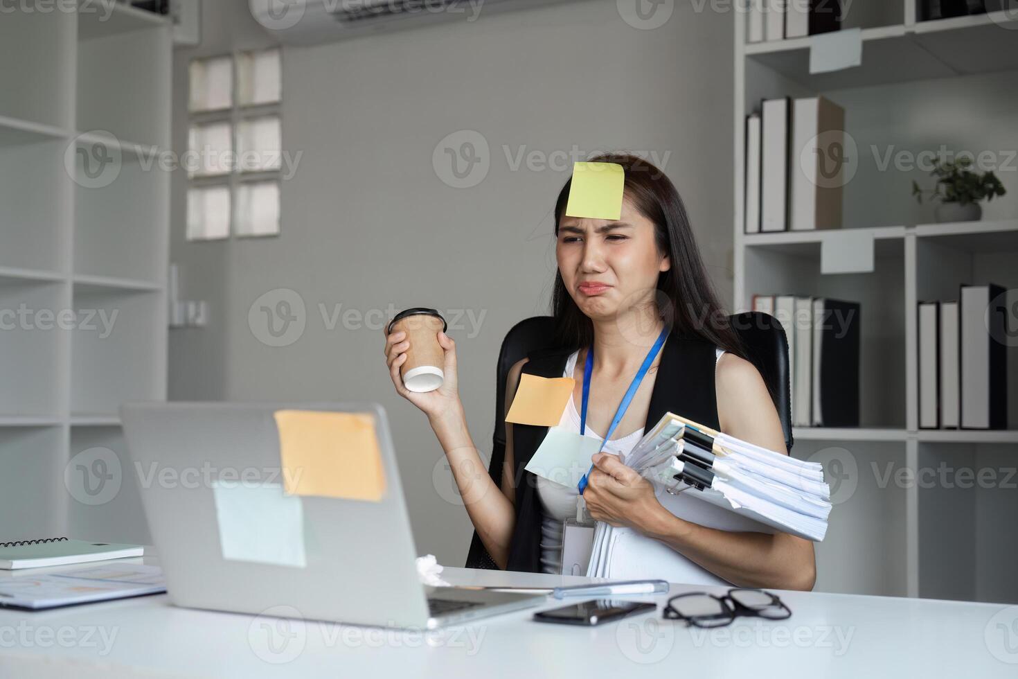Stressed Office Worker Juggling Documents and Coffee in a Modern Workspace photo