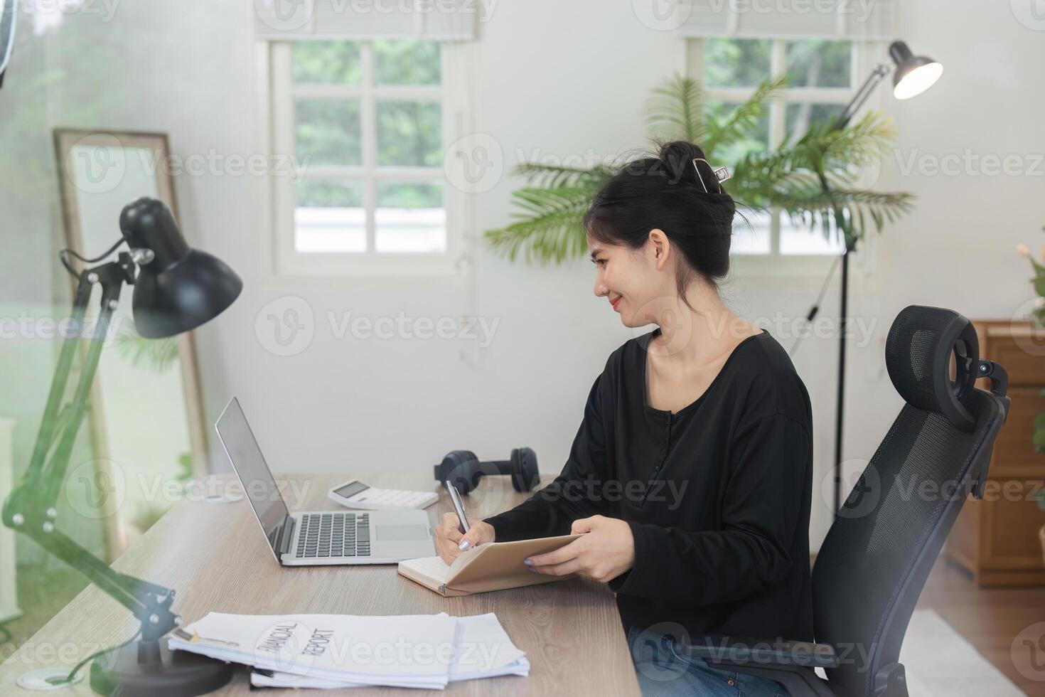 Young Accountant Working on Financial Documents in a Modern Office Setting with Natural Light and Greenery photo