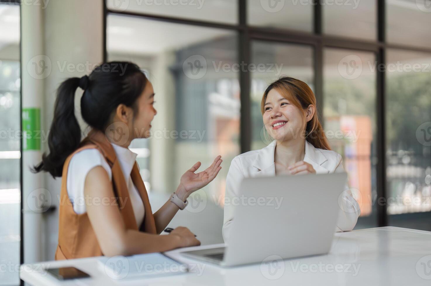 Accounting Team Engaged in Collaborative Discussion at Modern Office Workspace with Laptops and Documents photo