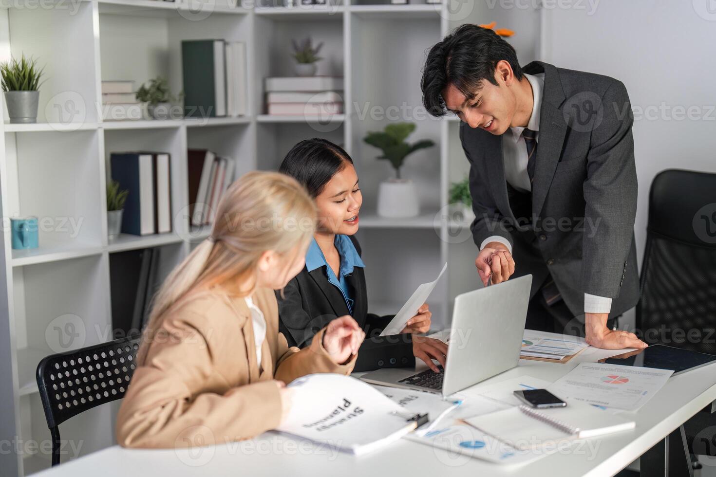 Diverse Business Team Collaborating on Project Strategy in Modern Office Environment photo