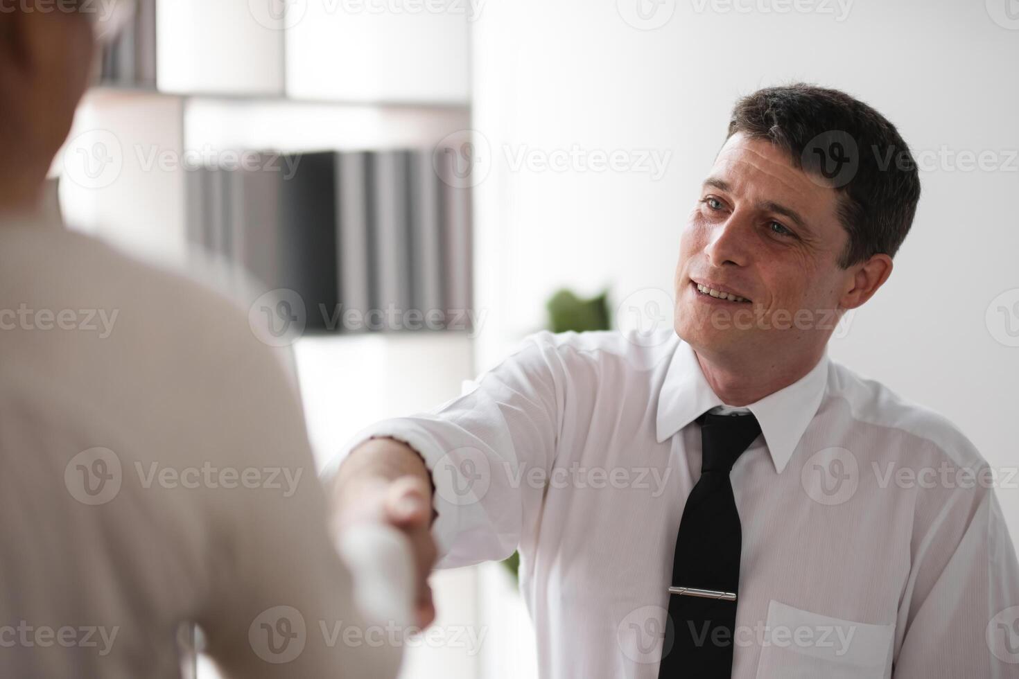 Close-up Businessman shaking hands with colleague in office, concept of agreement and partnership photo