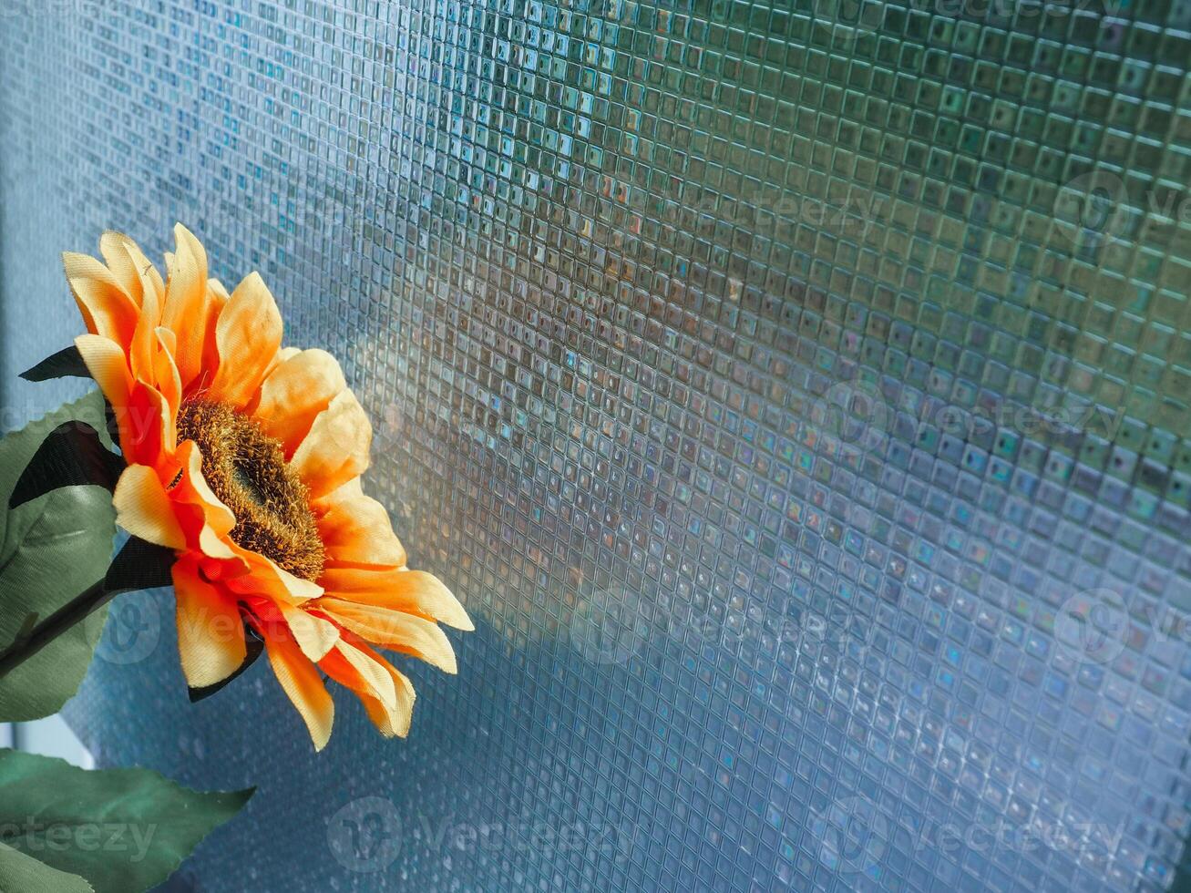 The fake flowers on the window express loneliness in winter. photo