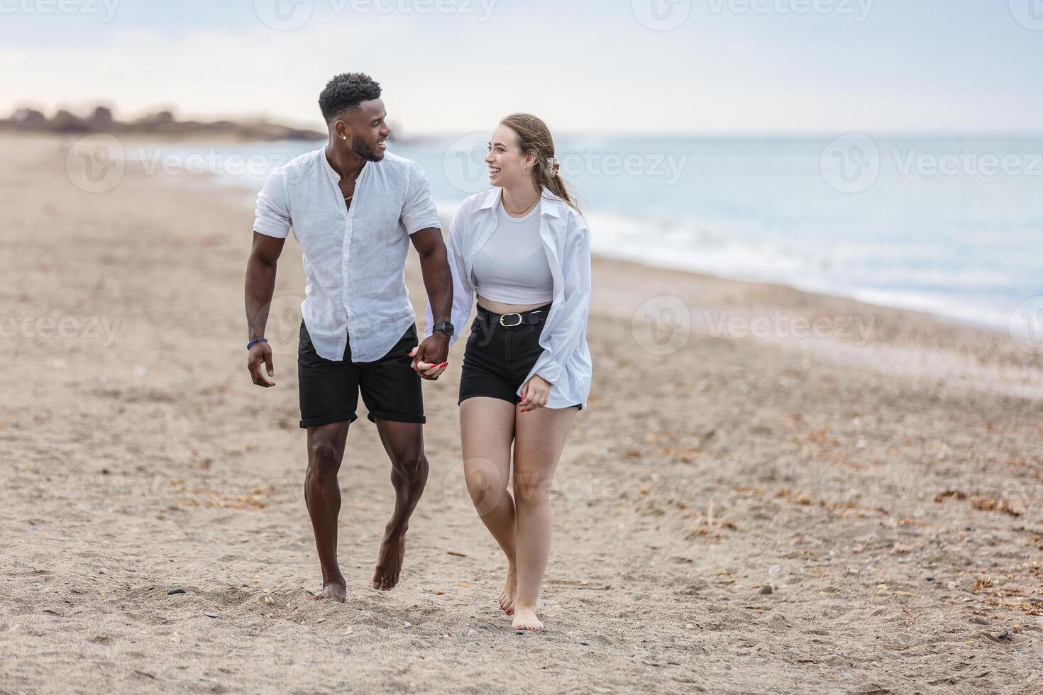 A couple strolls hand in hand along Zapillo beach in Almeria, Spain, enjoying a peaceful moment by the sea photo