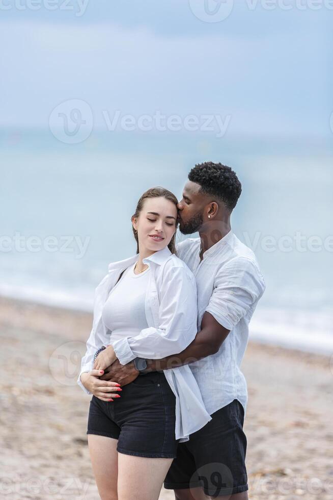 A couple enjoys a romantic walk on Zapillo beach in Almeria, Spain, embracing the sunset by the shore photo